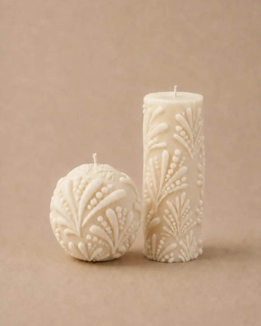 The Kindred, a sphere and a pillar candle pressed with the same pattern